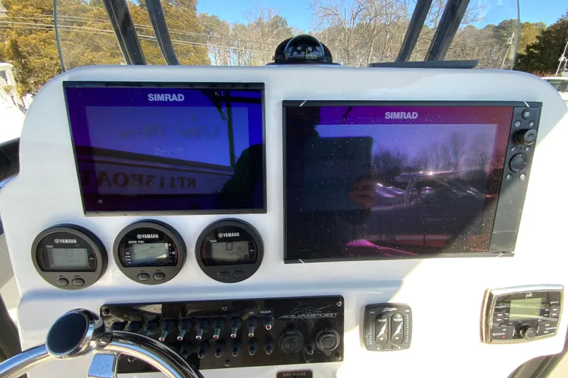 Slide: The Image of 2020 Aquasport 2500 Center Console dashboard with Simrad displays and Yamaha gauges. - 36