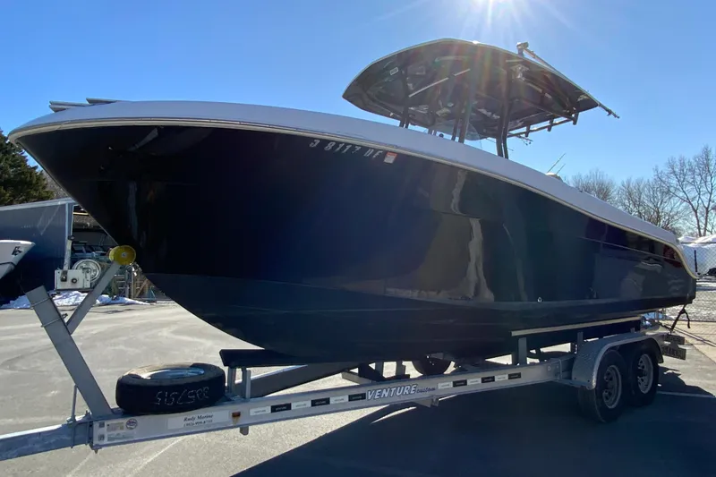 Slide: The Image of 2020 Aquasport 2500 Center Console boat on trailer under clear sky. - 5