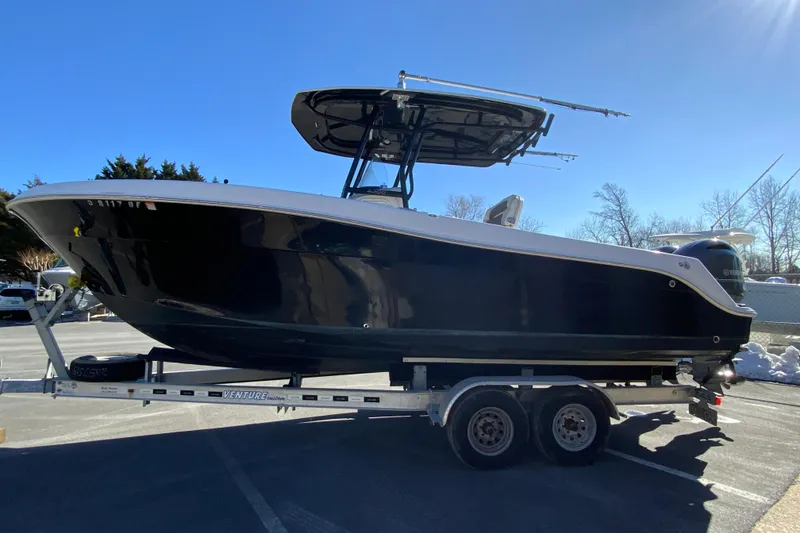 Slide: The Image of 2020 Aquasport 2500 Center Console boat on trailer, parked outdoors. - 6