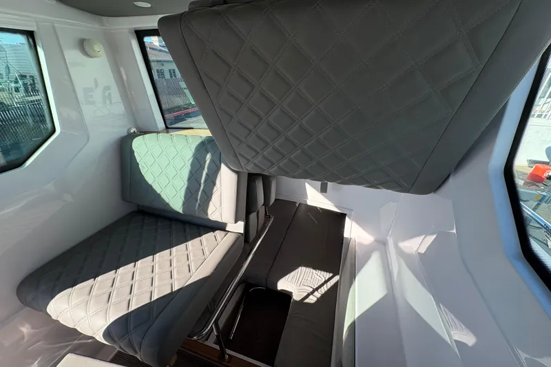Slide: The Image of Interior of 2021 Axopar 28 Cabin with quilted seating and modern design. - 14