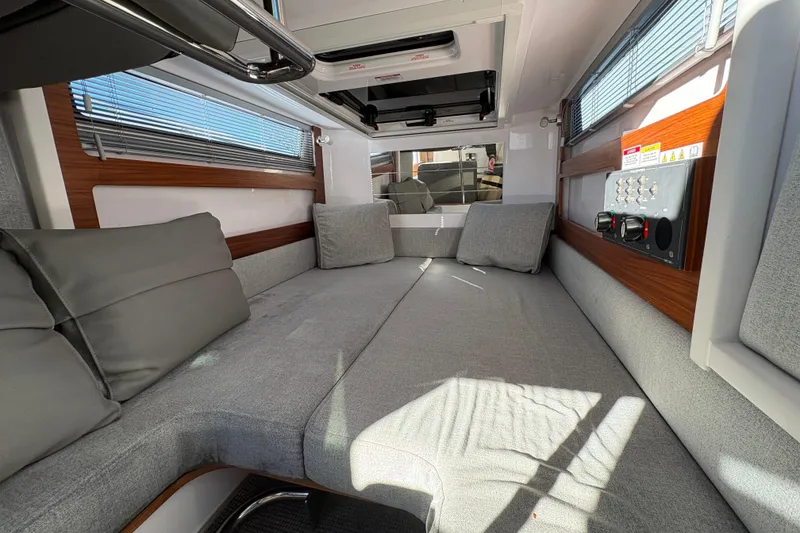 Slide: The Image of 2021 Axopar 28 Cabin interior with gray seating and modern design. - 15