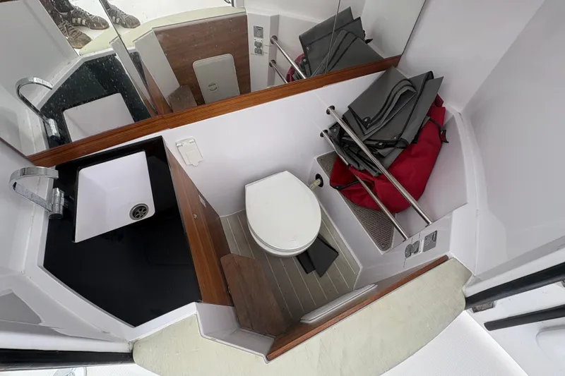 Slide: The Image of Interior of 2021 Axopar 28 Cabin with toilet and sink. - 16