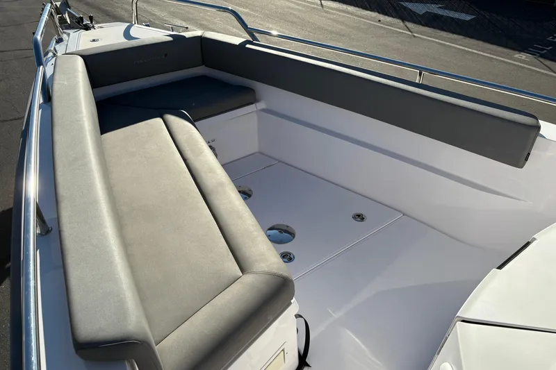 Slide: The Image of 2021 Axopar 28 Cabin boat interior with gray seating and sleek design. - 8