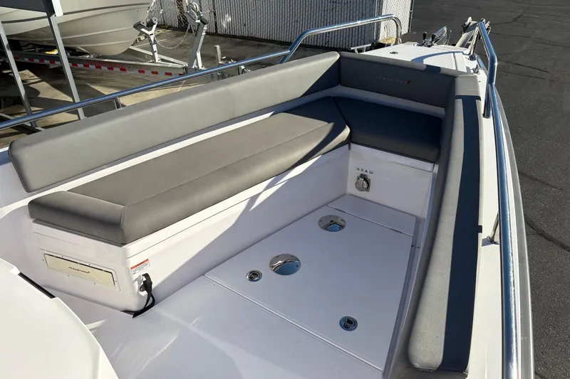 Slide: The Image of 2021 Axopar 28 Cabin boat interior with gray seating and deck details. - 9