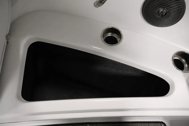 Slide: The Image of Interior storage compartment of 2026 Four Winns H4 Freedom boat with cup holders. - 13