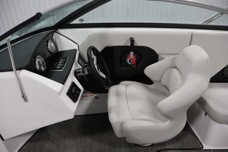 Slide: The Image of 2026 Four Winns H4 Freedom boat interior with modern dashboard and plush captain's seat. - 16