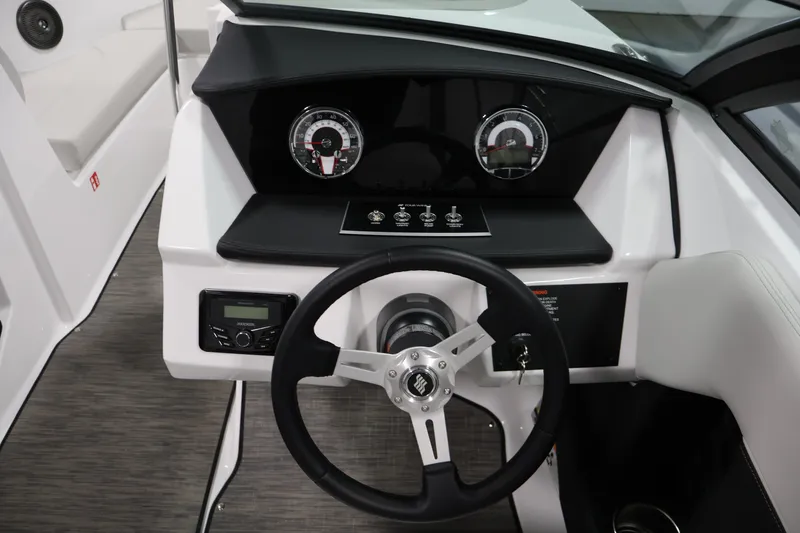 Slide: The Image of 2026 Four Winns H4 Freedom boat dashboard with steering wheel and gauges. - 17