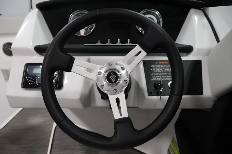 Slide: The Image of Steering wheel of 2026 Four Winns H4 Freedom boat with dashboard controls. - 18