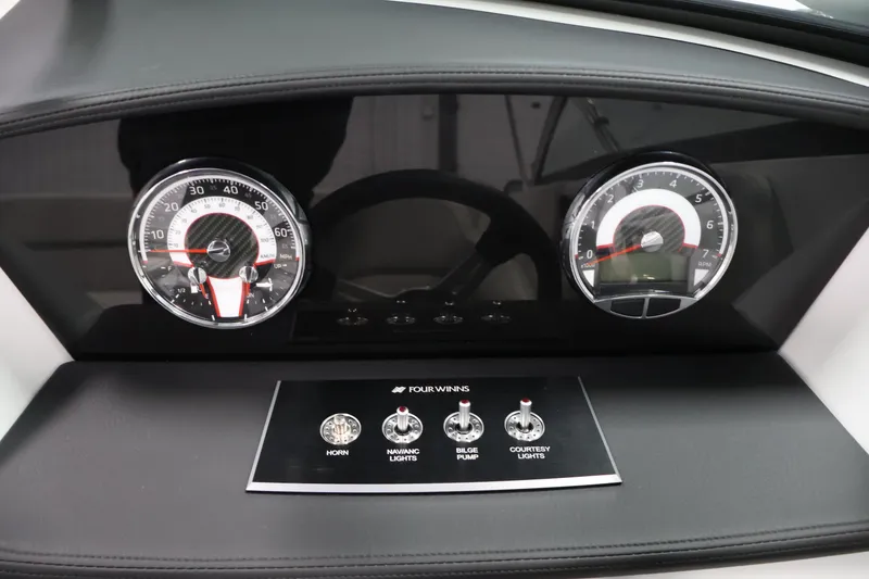 Slide: The Image of Dashboard of 2026 Four Winns H4 Freedom boat with gauges and control switches. - 19