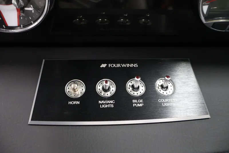 Slide: The Image of Control panel of 2026 Four Winns H4 Freedom boat with switches for horn, lights, and pump. - 20