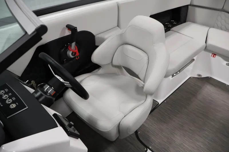Slide: The Image of 2026 Four Winns H4 Freedom boat interior with sleek white captain's chair and modern dashboard. - 22