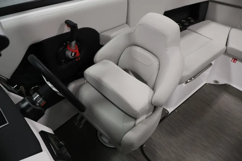 Slide: The Image of 2026 Four Winns H4 Freedom boat interior with sleek steering and comfortable seating. - 23