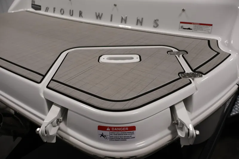 Slide: The Image of 2026 Four Winns H4 Freedom boat swim platform with safety warning label. - 34