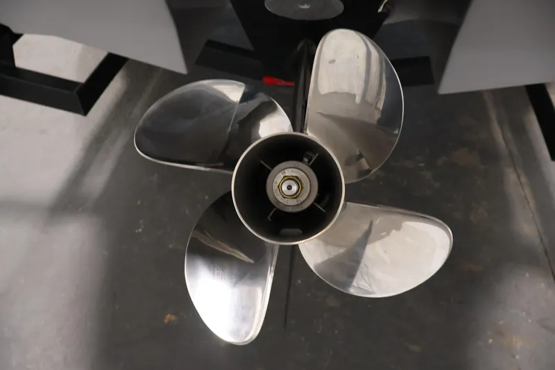 Slide: The Image of 2026 Four Winns H4 Freedom boat propeller, close-up view in a garage setting. - 37