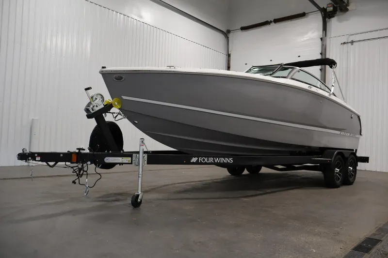 Slide: The Image of 2026 Four Winns H4 Freedom boat on trailer in indoor storage. - 40