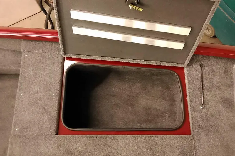 Slide: The Image of 2026 Ranger RT188 boat storage compartment with open lid, featuring carpeted interior. - 12