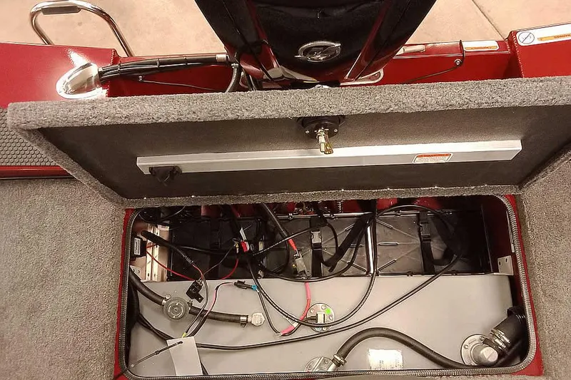Slide: The Image of 2026 Ranger RT188 boat storage compartment with wiring and components visible. - 23