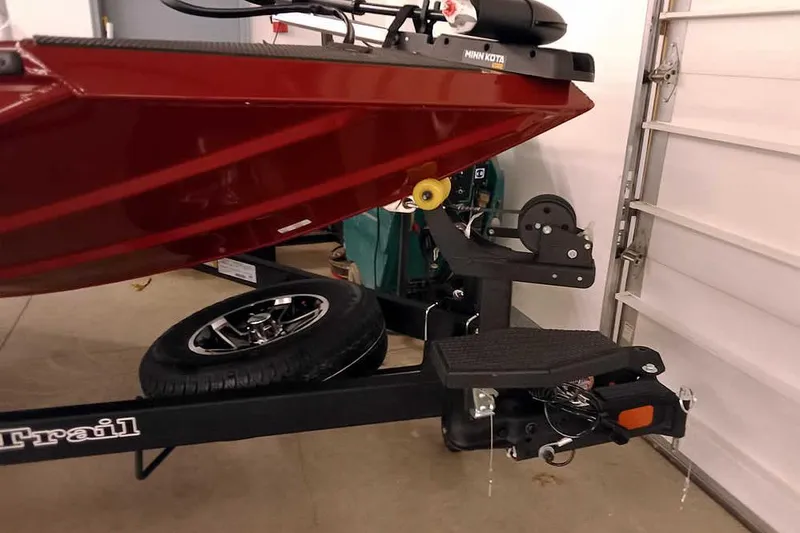 Slide: The Image of 2026 Ranger RT188 boat on trailer in garage, featuring Minn Kota motor. - 4