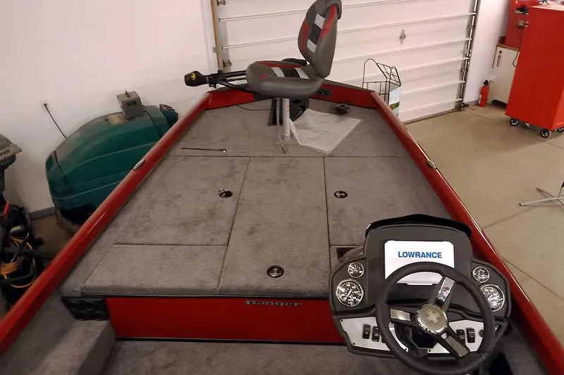 Slide: The Image of 2026 Ranger RT188 boat interior with steering console and fishing seat in a garage. - 8
