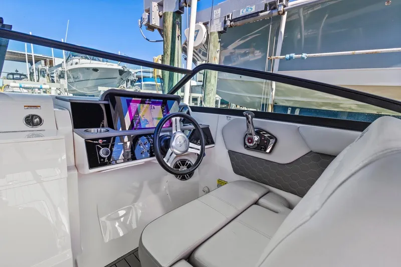 Slide: The Image of 2023 Sea Ray SDX 250 Outboard helm with modern controls and navigation display. - 10