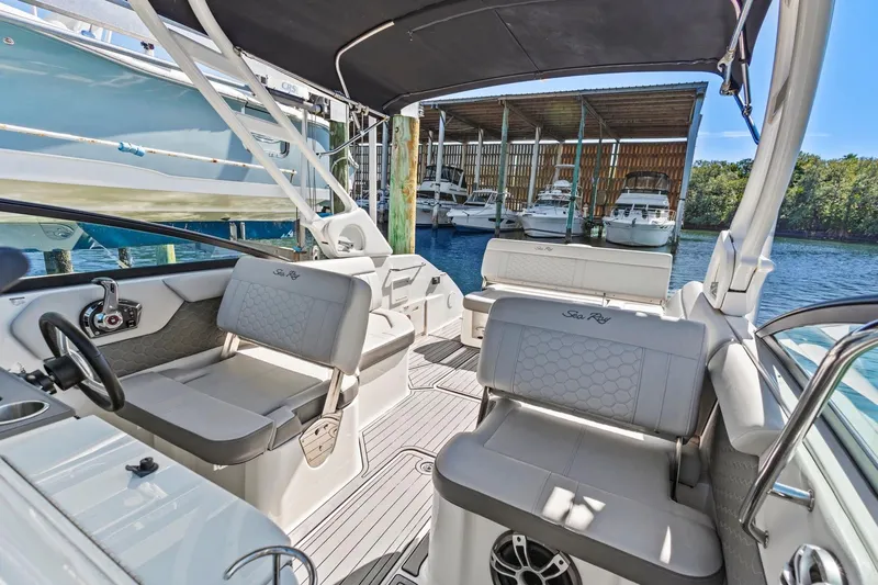 Slide: The Image of 2023 Sea Ray SDX 250 Outboard interior with seating, docked at marina. - 11