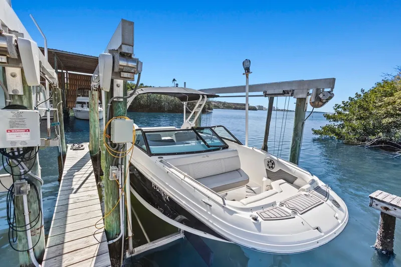 Slide: The Image of 2023 Sea Ray SDX 250 Outboard boat docked on a sunny day. - 14