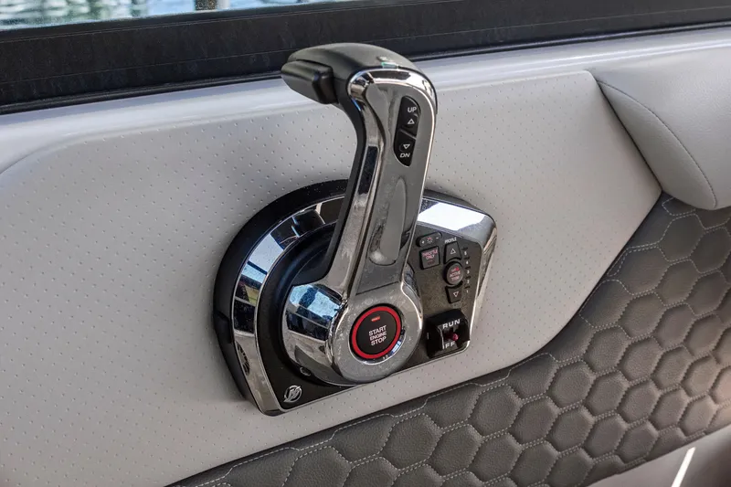 Slide: The Image of 2023 Sea Ray SDX 250 Outboard throttle control on luxury boat interior. - 16