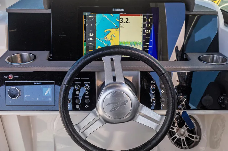 Slide: The Image of 2023 Sea Ray SDX 250 Outboard dashboard with steering wheel and navigation display. - 17