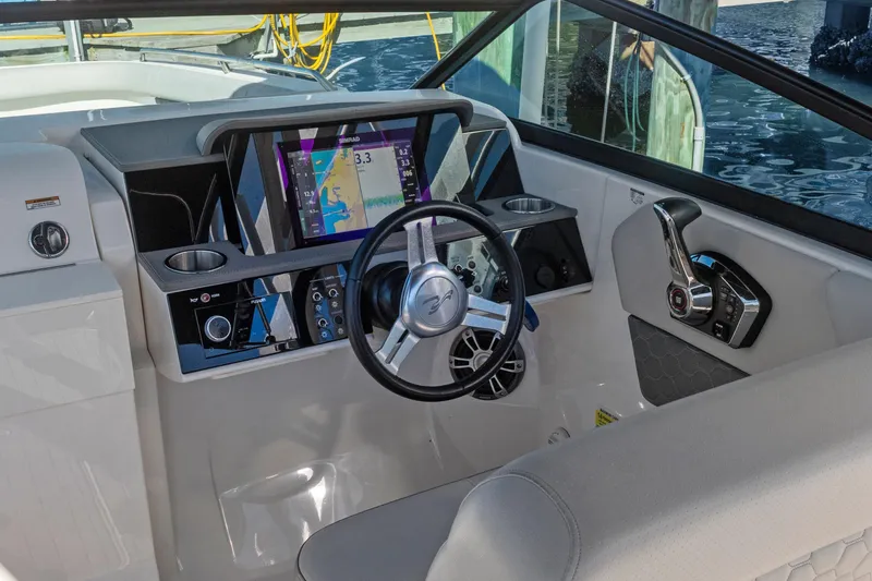 Slide: The Image of 2023 Sea Ray SDX 250 Outboard helm with modern controls and navigation display. - 20