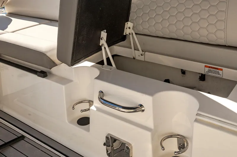 Slide: The Image of 2023 Sea Ray SDX 250 Outboard boat seat storage compartment with cup holders. - 21