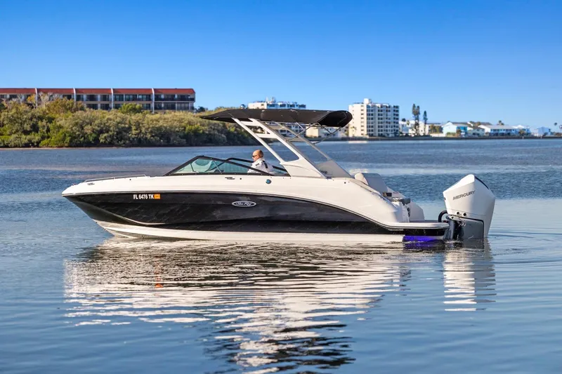 Slide: The Image of 2023 Sea Ray SDX 250 Outboard boat on calm water with scenic background. - 3