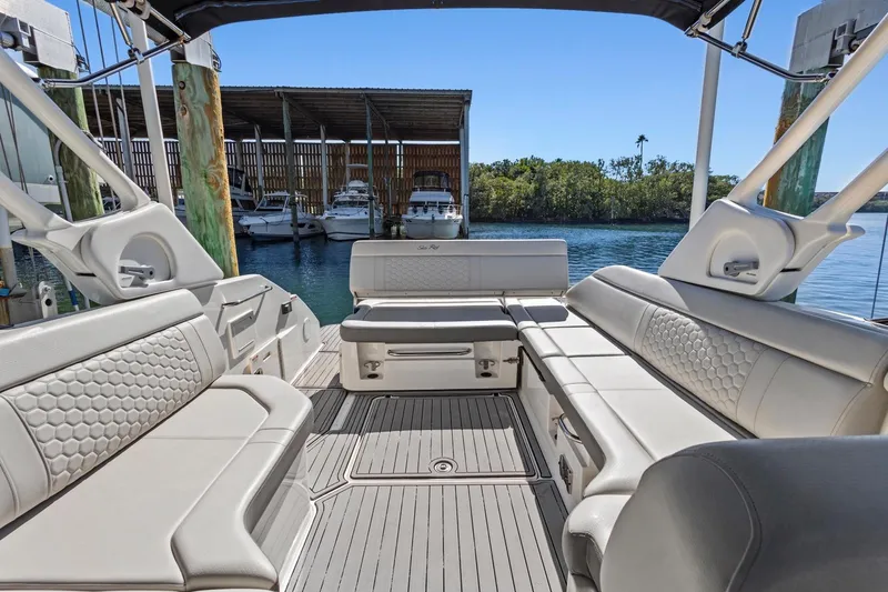 Slide: The Image of 2023 Sea Ray SDX 250 Outboard interior with luxurious seating and waterfront view. - 9