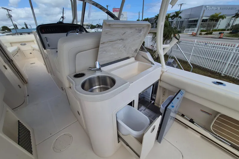 Slide: The Image of 2026 Grady-White Freedom 307 boat interior with sink and storage compartments. - 18