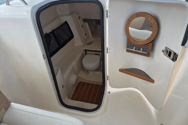 Slide: The Image of 2026 Grady-White Freedom 307 boat interior with toilet and mirror. - 20