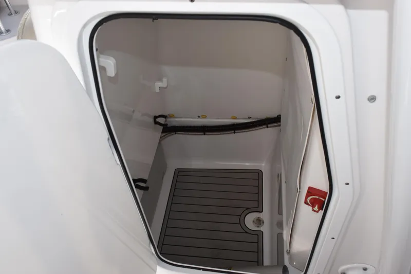 Slide: The Image of 2021 Sportsman Heritage 241 Center Console storage compartment, open door view. - 15