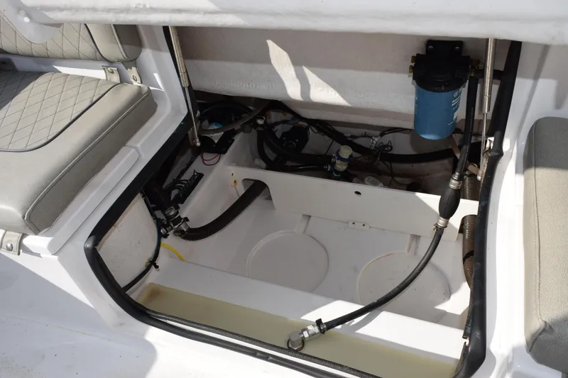 Slide: The Image of 2021 Sportsman Heritage 241 Center Console interior compartment with seating and mechanical components. - 20