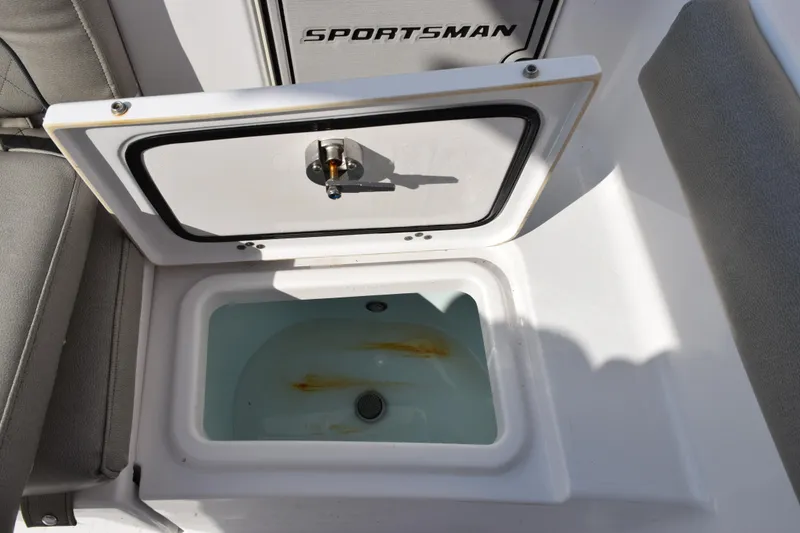 Slide: The Image of 2021 Sportsman Heritage 241 Center Console livewell with open lid and water inside. - 21