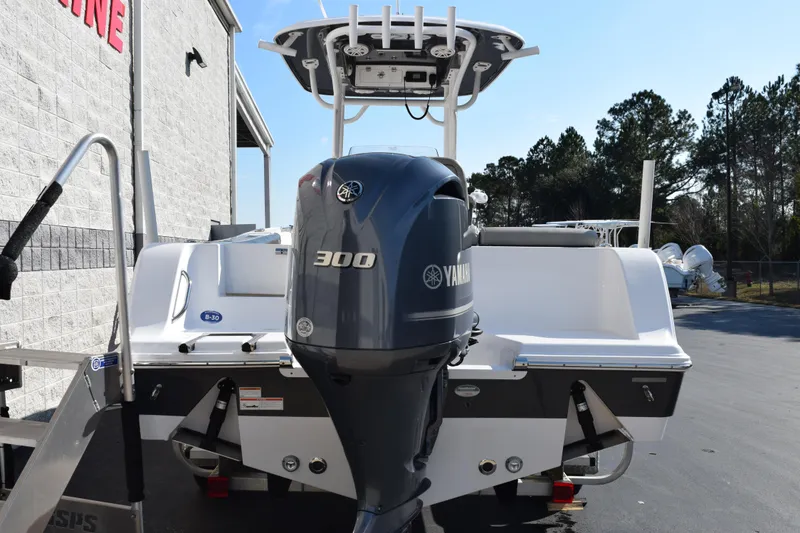 Slide: The Image of 2021 Sportsman Heritage 241 Center Console boat with Yamaha 300 engine, parked outdoors. - 5