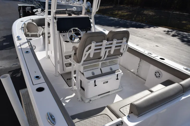 Slide: The Image of 2021 Sportsman Heritage 241 Center Console boat interior with seating and steering console. - 8