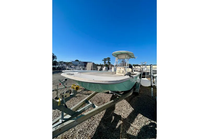 Slide: The Image of 2018 Carolina Skiff 238 DLV boat on trailer under clear blue sky. - 6