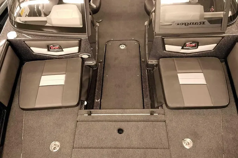 Slide: The Image of 2026 Ranger 2050MS Reata boat interior with dual seating and carpeted flooring. - 12