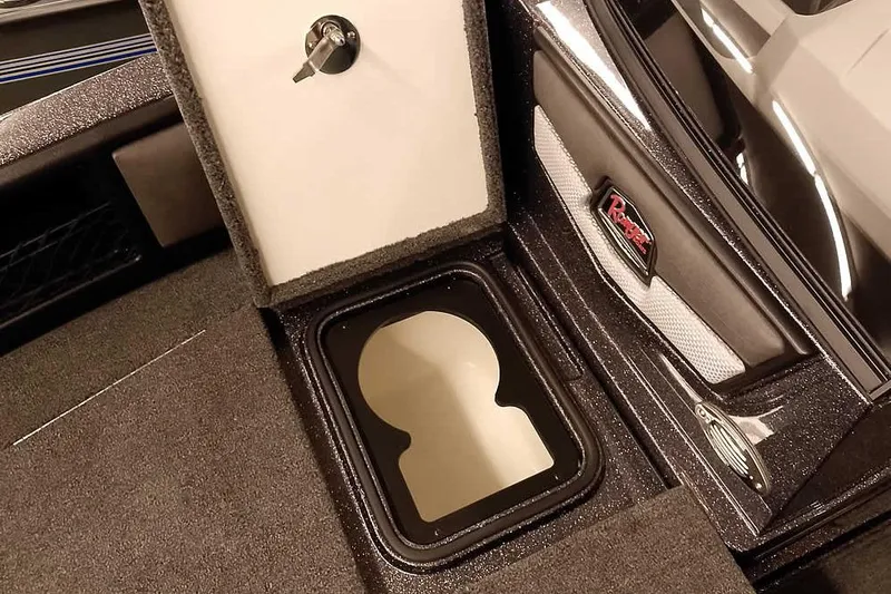 Slide: The Image of 2026 Ranger 2050MS Reata boat storage compartment with key lock and sleek interior design. - 14