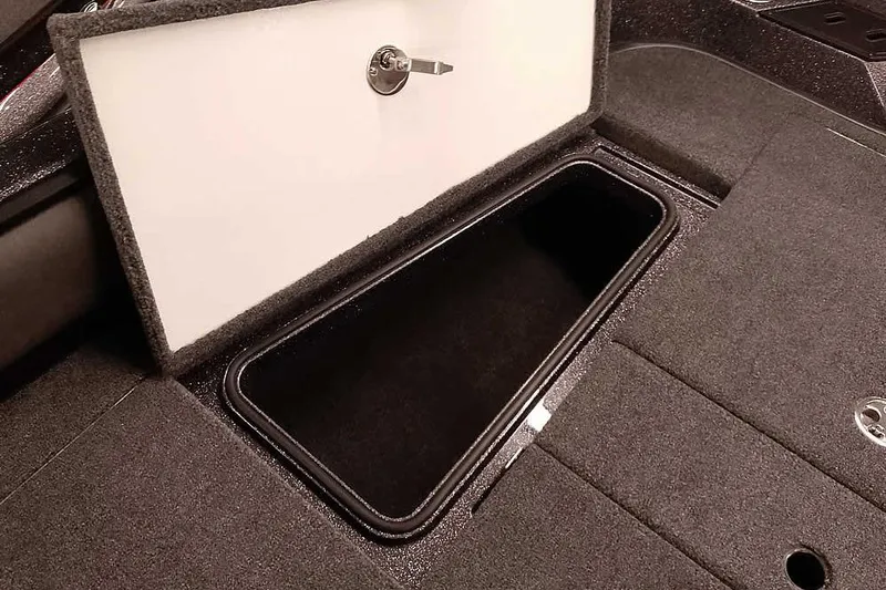 Slide: The Image of Storage compartment in 2026 Ranger 2050MS Reata boat, featuring secure lock and carpeted interior. - 18