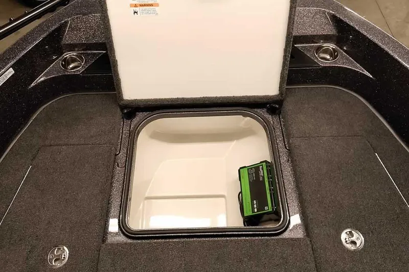 Slide: The Image of 2026 Ranger 2050MS Reata boat storage compartment with open hatch and visible equipment. - 19