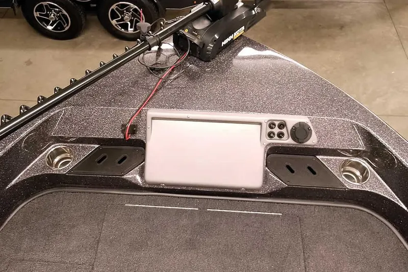 Slide: The Image of 2026 Ranger 2050MS Reata boat dashboard with control panel and cup holders. - 21