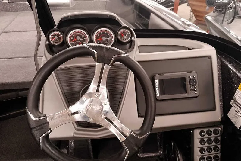 Slide: The Image of 2026 Ranger 2050MS Reata boat dashboard with steering wheel and navigation system. - 32
