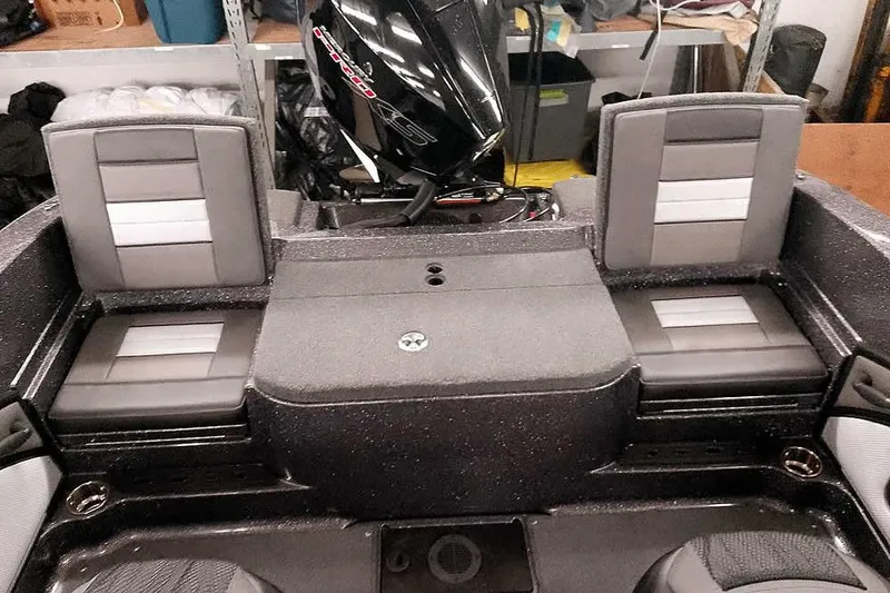 Slide: The Image of 2026 Ranger 2050MS Reata boat interior with cushioned seating and motor. - 37