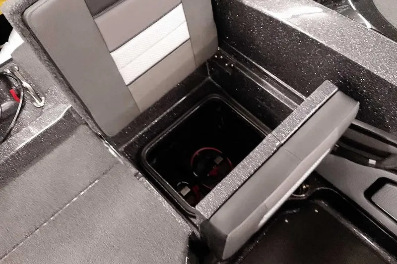 Slide: The Image of 2026 Ranger 2050MS Reata boat interior with storage compartment and cushioned seating. - 38