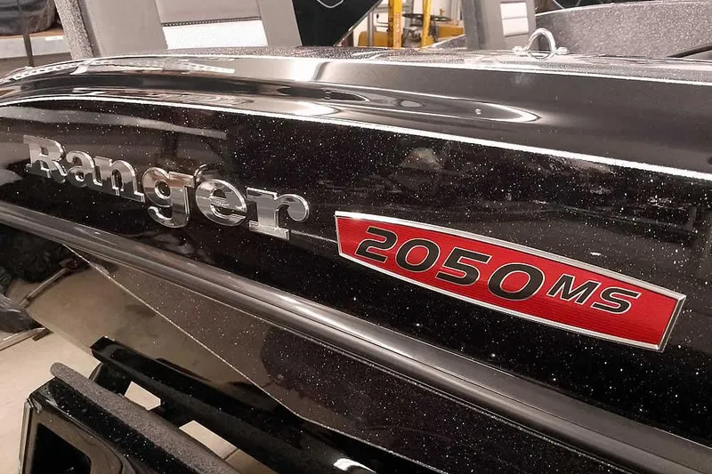 Slide: The Image of 2026 Ranger 2050MS Reata boat with sleek black finish and red model emblem. - 4