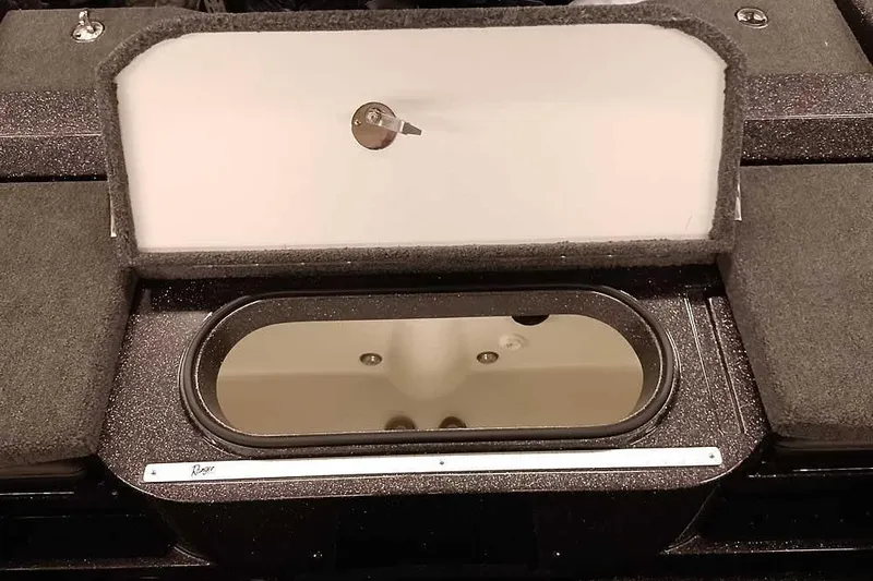 Slide: The Image of 2026 Ranger 2050MS Reata boat storage compartment with open lid and sleek design. - 41